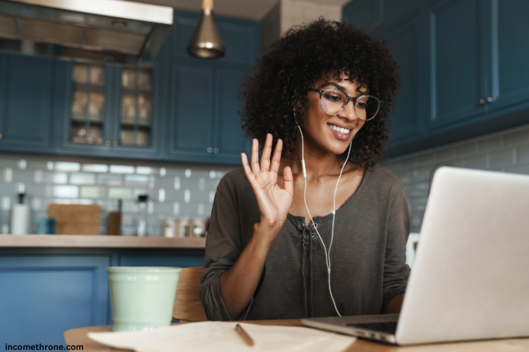 young woman on call with friend on laptop